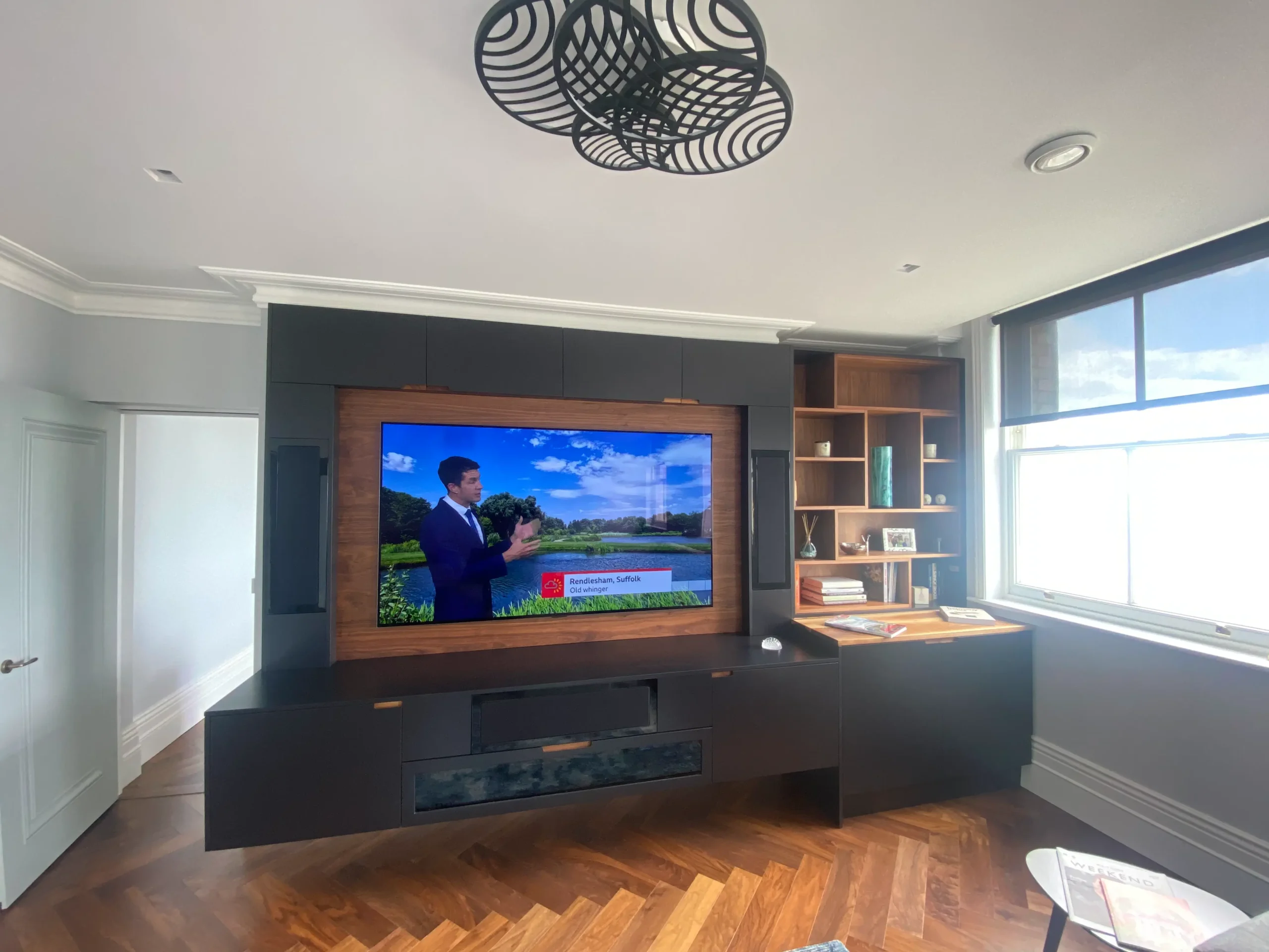 Luxury bespoke joinery media unit in dark grey for a man cave or media room.