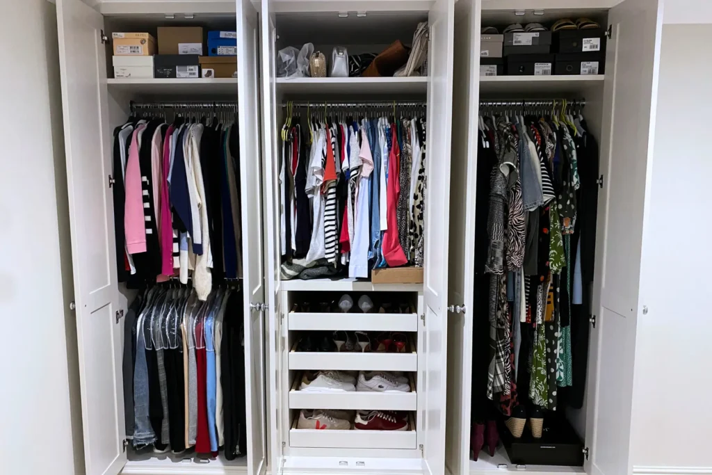 White built in wardrobe, with internal drawers and shelves bespoke storage solutions.