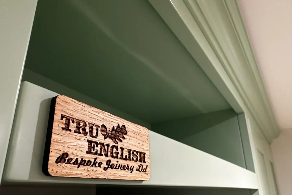 Custom Joinery Services in Surrey showing a closeup of a green kitchen cabinet