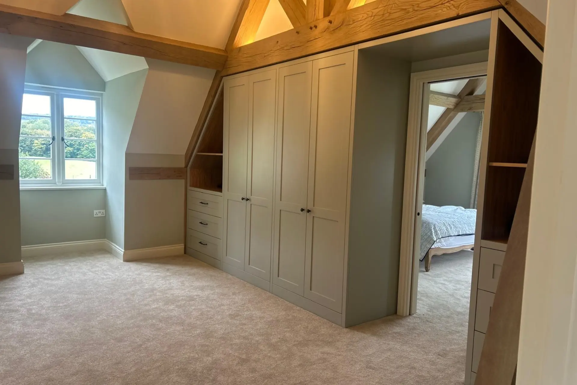 Sage green fitted wardrobes as a dressing room