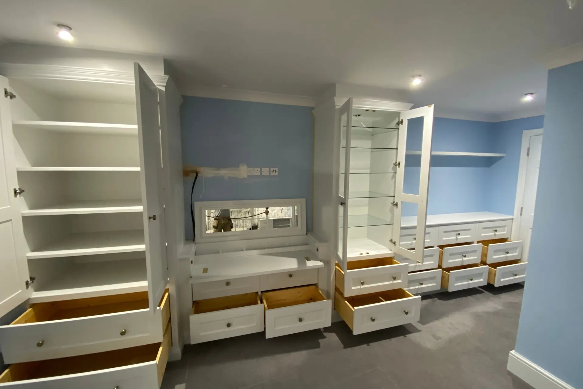 Opened white bespoke fitted wardrobes cupboards and drawers