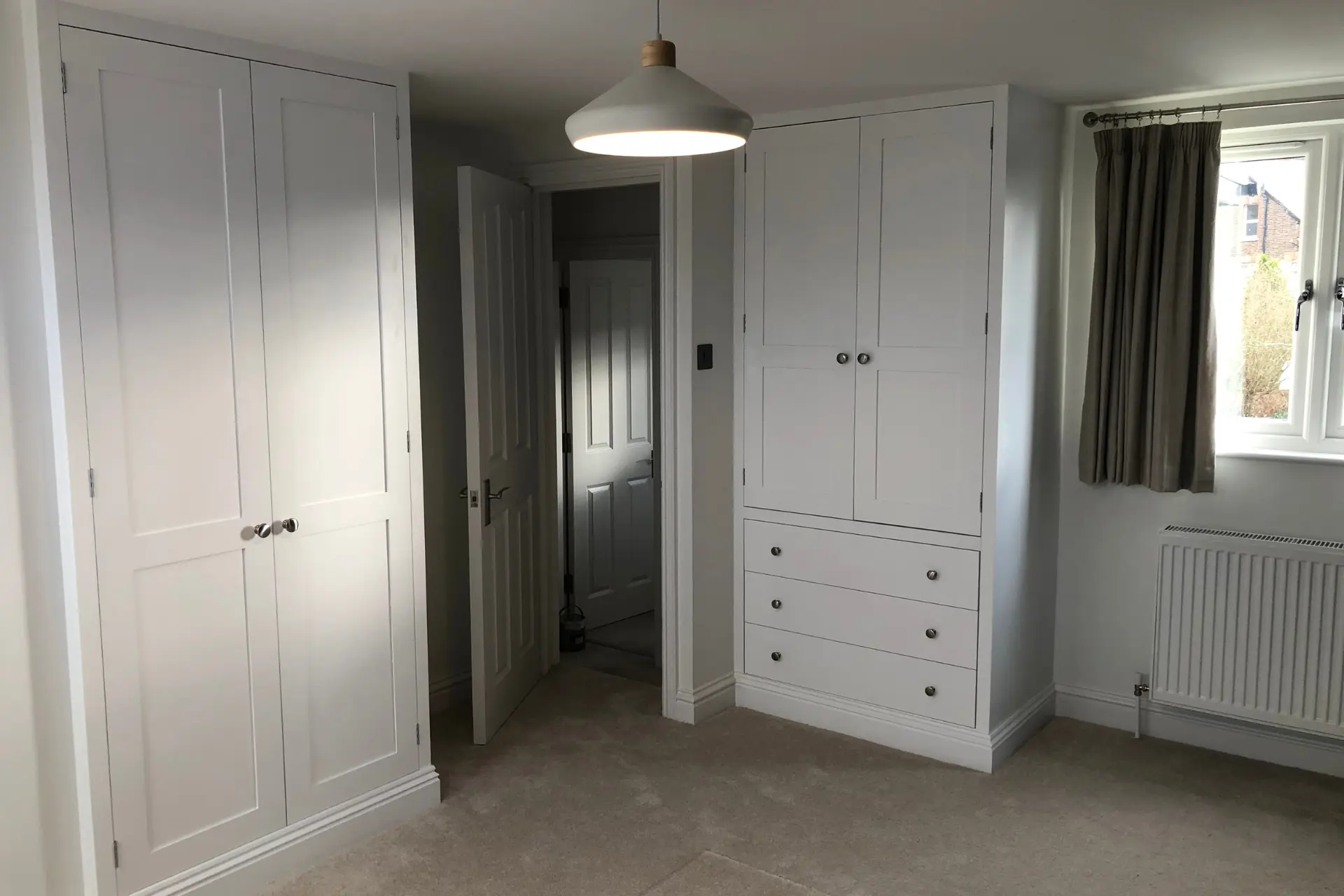 white fitted wardrobes and drawers in a bedroom