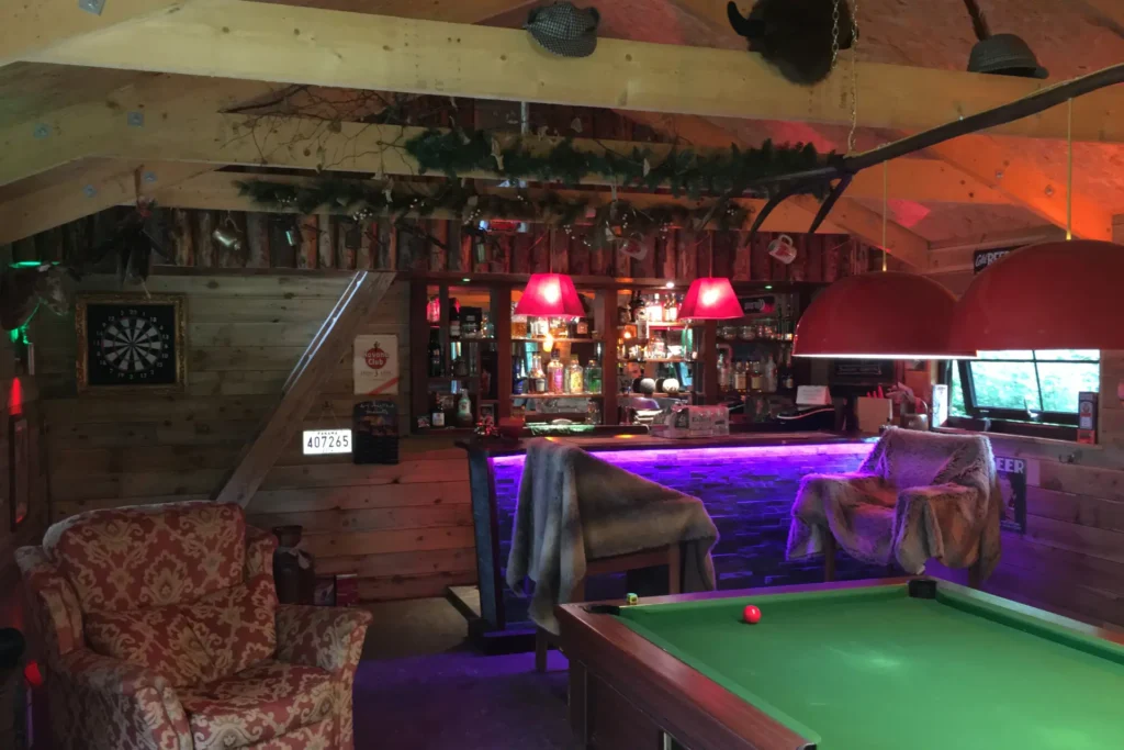 Premium man caves with a bar, pool table and armchair