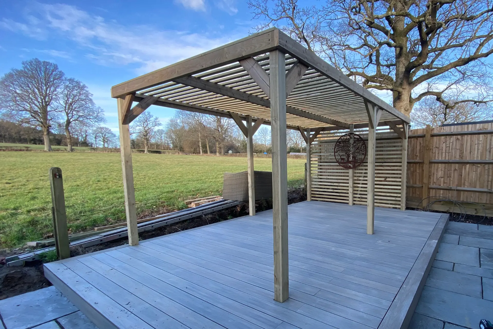 Timber gazebo on a decked area in a garden