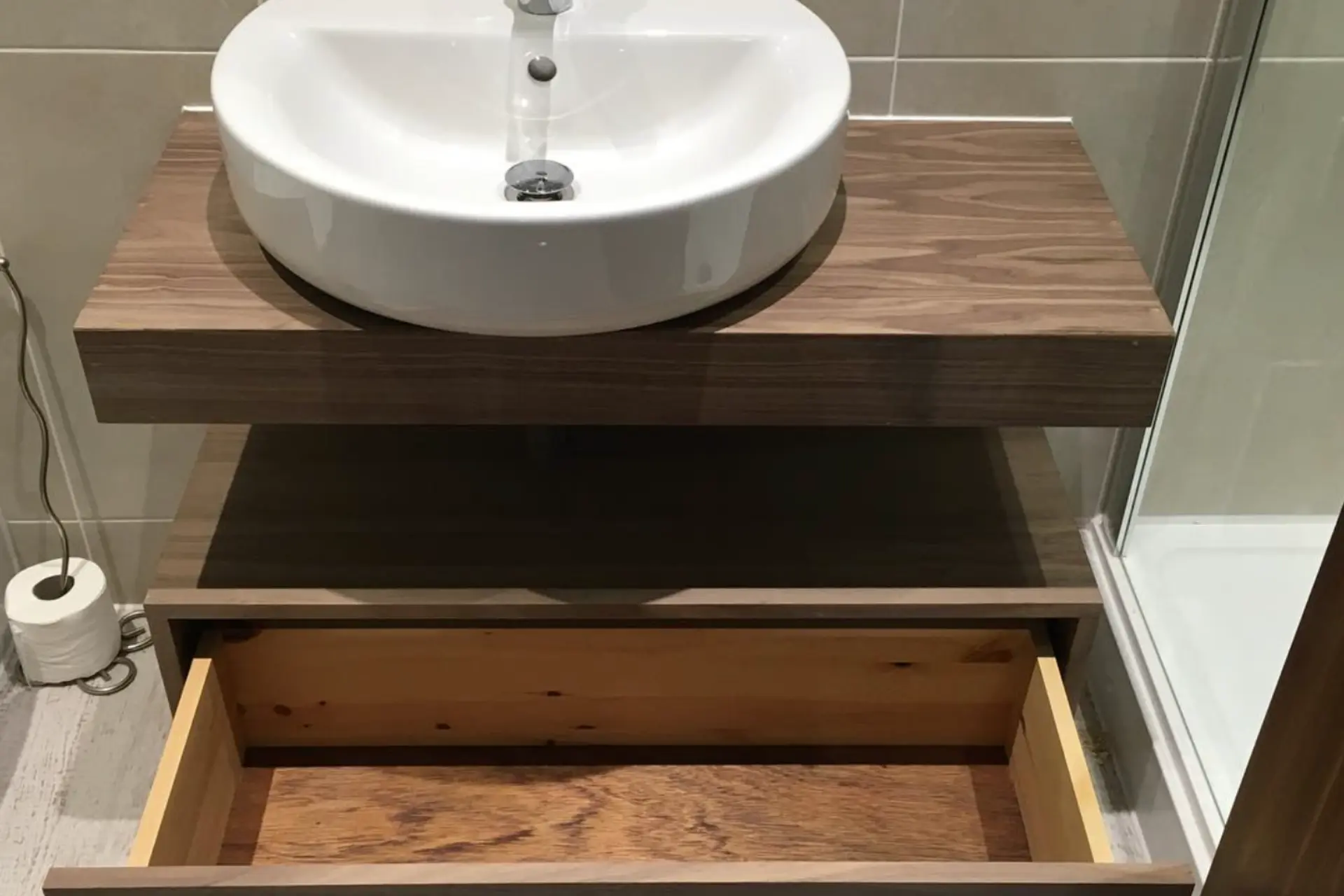 bespoke bathroom joinery dark wood vanity unit with a sink and drawer