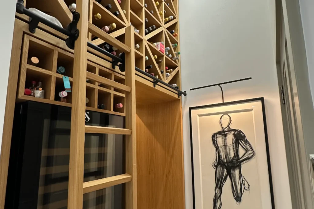 oak shelving and ladder bespoke wine cellar design