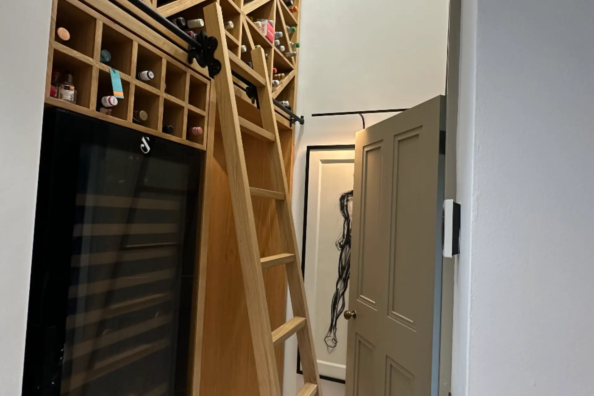 oak bespoke wine cellar floor to ceiling with a ladder