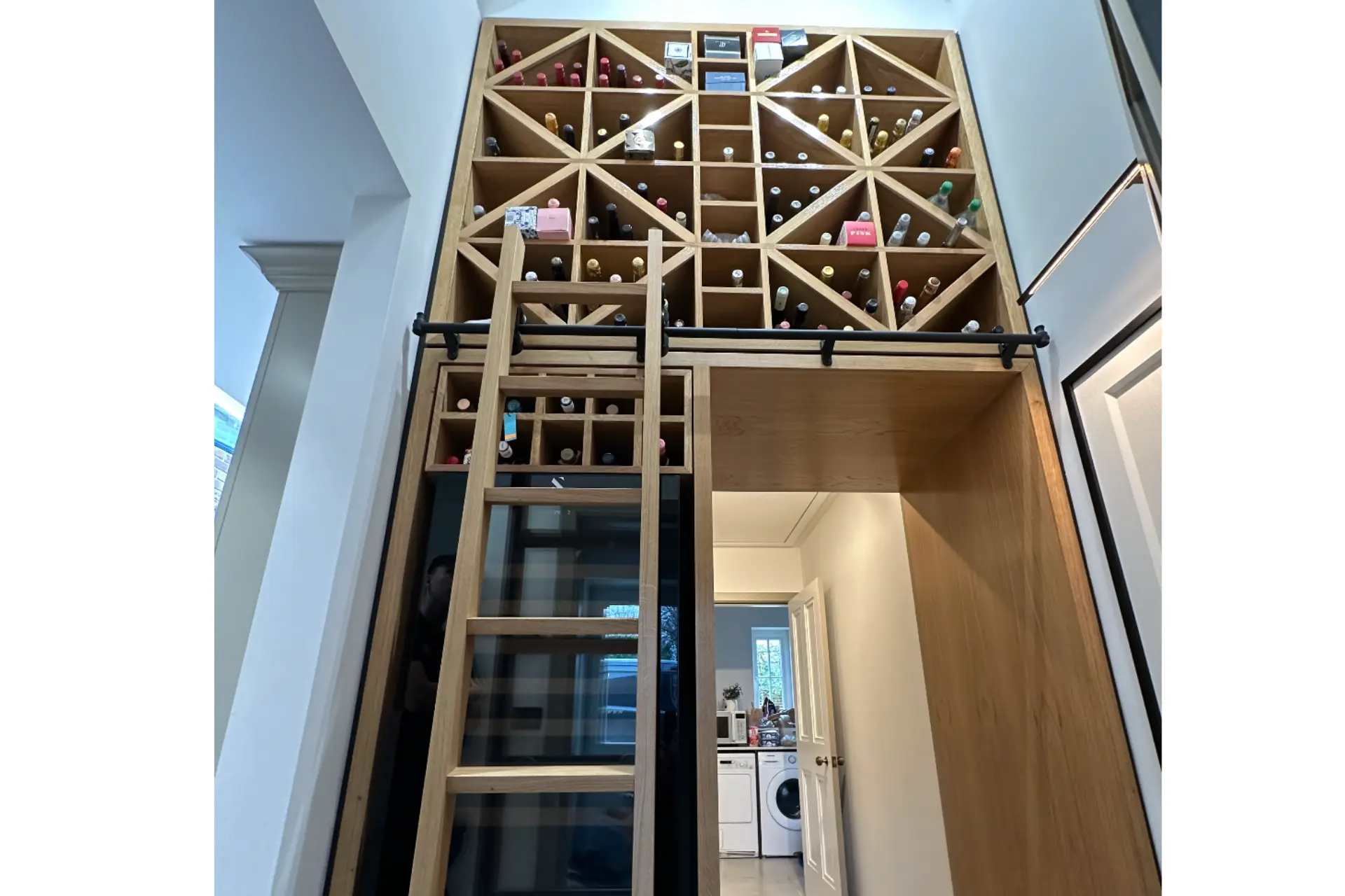 floor to ceiling bespoke oak wine cellar shelving and ladder