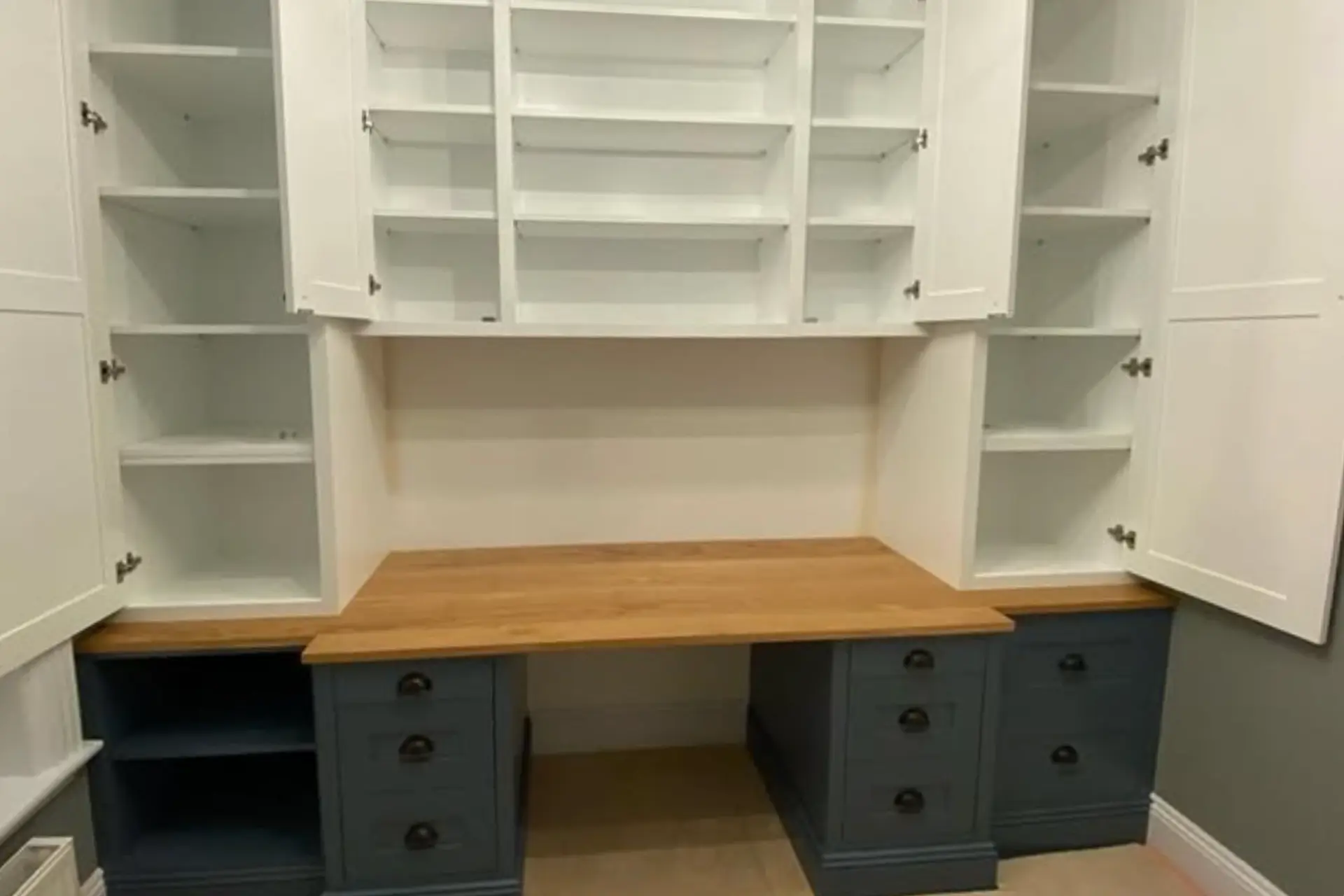 made-to-measure workspace with a handcrafted oak desk and white fitted office storage in a home study