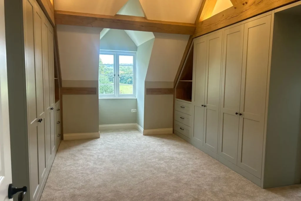 sage green Walk-In Wardrobes in a bedroom with a dorma window