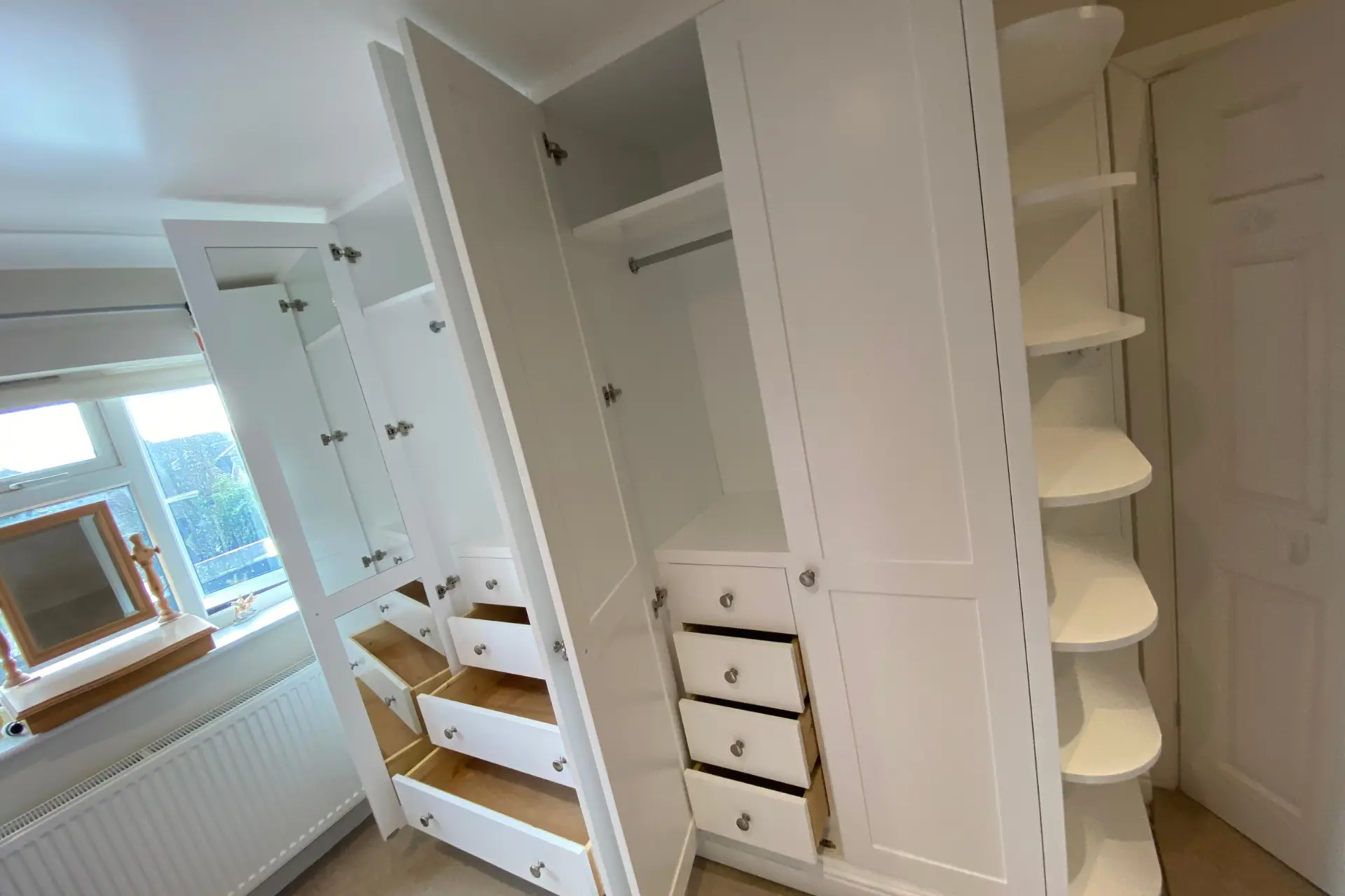 white fitted wardrobes with cupboards, drawers and shelving