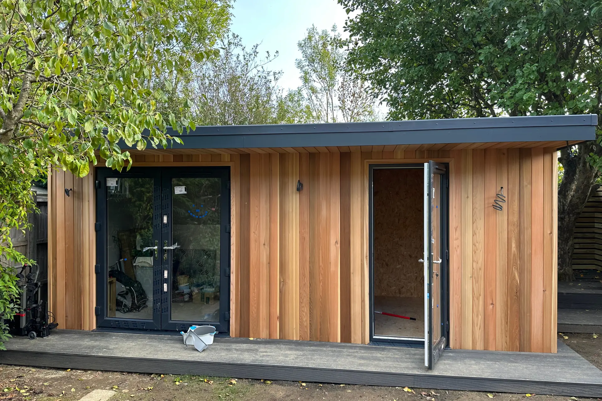 a modern wood garden room with an open door