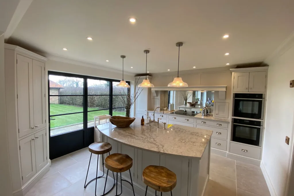 white and grey kitchen and a curved island, 2025 kitchen trends