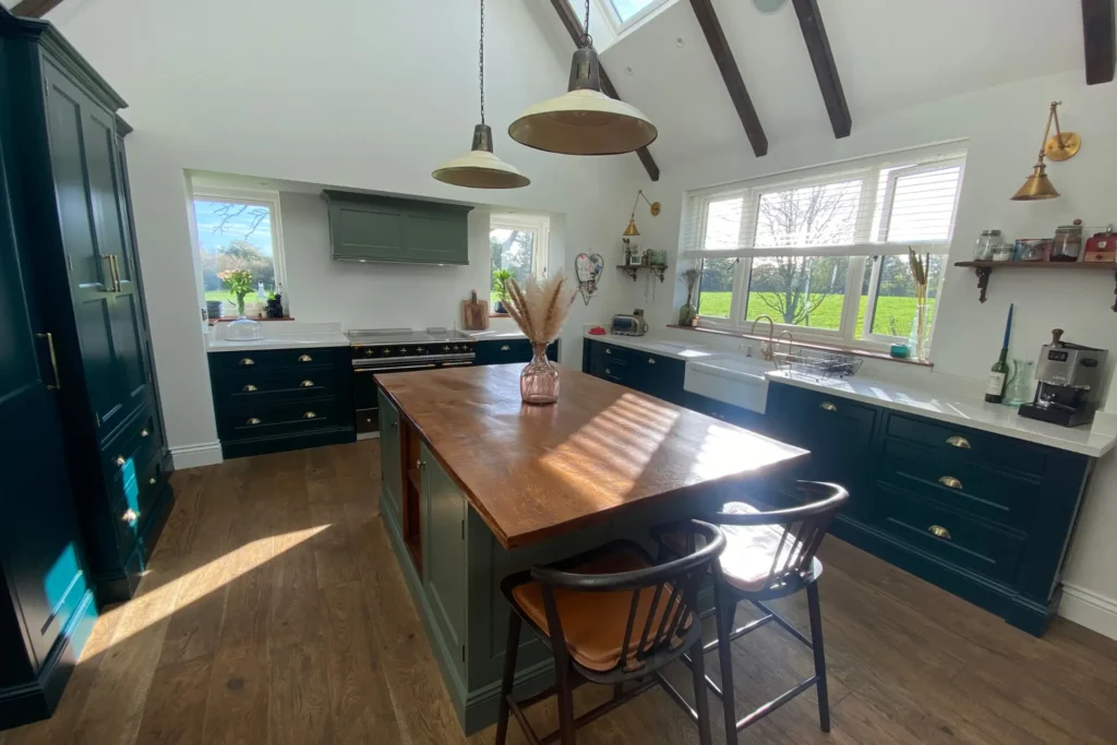 Eco-Friendly Home Improvements with Joinery kitchen island with oak worktop and dark green cabinets