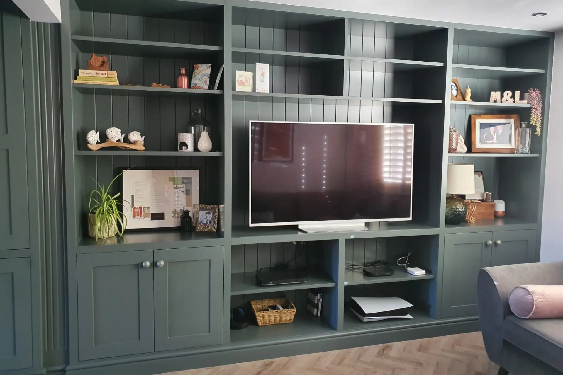 dark teal coloured bespoke tv shelving, cabinets and drawers