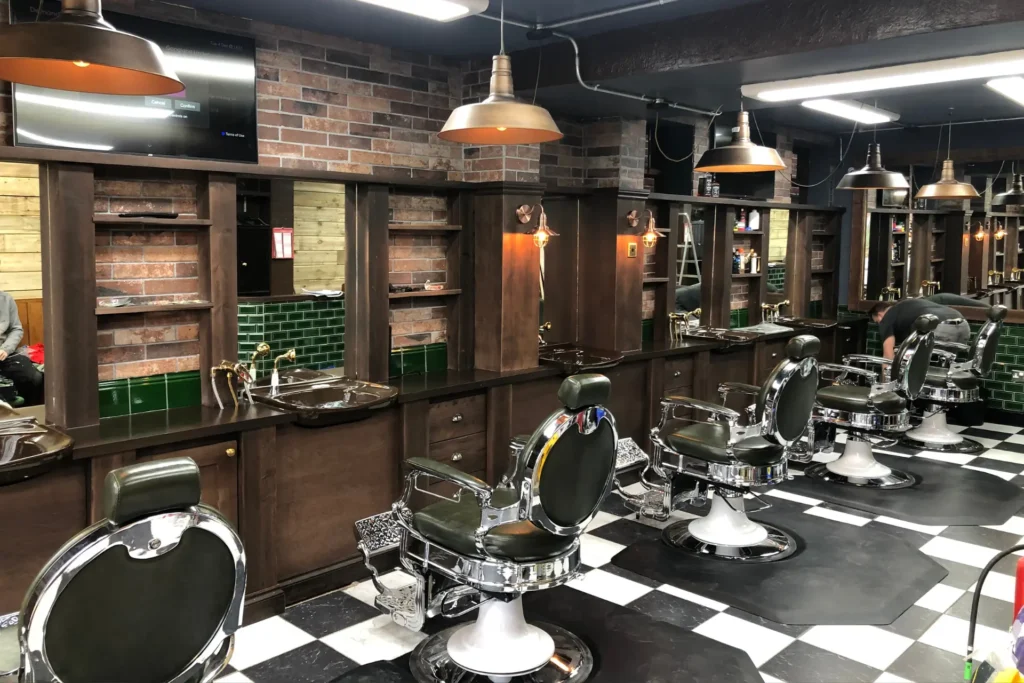 Commercial joinery dark wood shelving in a barbers