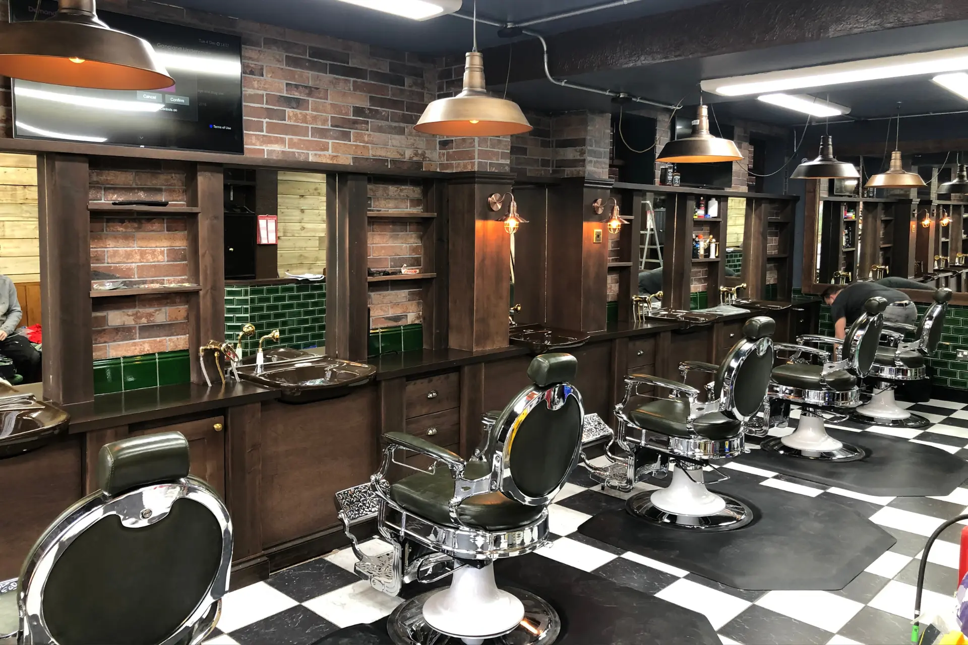 Commercial joinery dark wood shelving in a barbers